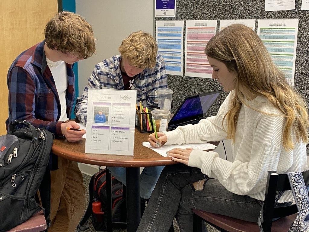 Students tutoring other students at a library table.